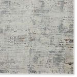 Close-up of the rug surface focusing on distressed abstract pattern with grid-like details and color texture