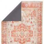 Back side of the Rhoda Medallion rug with a dark solid backing partially folded over the front design