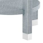 Close-up on table leg showing silver metal cap and rinsed lacquered linen surface texture