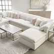 Sideboard placed in living room behind white sectional sofa with soft natural light