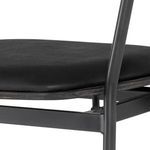 Close-up of the leather seat cushion and metal frame junction with wood layering detail