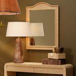 Hilltop Raffia Arch Wall Mirror hanging above textured beige console table with wooden lamp and decor