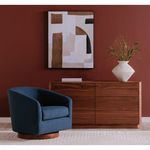 Oscy Swivel Chair styled in living room setting near wooden credenza and abstract wall art