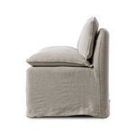 Side profile highlighting cushioning thickness and relaxed slipcover drape reaching to floor