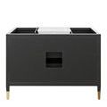 bathroom setup featuring black vanity with gold fixtures next to marble bathtub and window