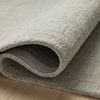 Close-up of curled edge showing thickness and dense wool and jute weave of Polly Fog / Wheat rug