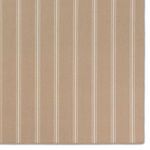 Zoomed-in view of rug corner showing tight flatwoven edge with beige and ivory stripes