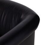 Focus on chair seat featuring dense leather upholstery with smooth matte finish