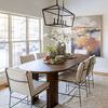 Rug placed under a wooden dining table in a modern room with natural light and neutral decor