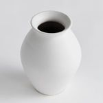 Top-down angle showing wide flared rim and dark interior of the white glazed terracotta vase