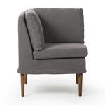Cozy corner dining banquette in broadway denim flax linen with amber oak legs, clean lines, and plush cushions