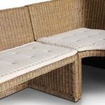Close-up detail of the tufted cream fabric cushions across joined bench sections