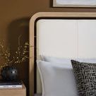 Side close-up showing leather headboard with smooth padding and wood frame details