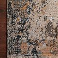 Leigh Silver Multi Rug with abstract distressed motifs in beige, gray, orange, and teal tones on dark hardwood floor