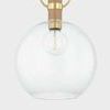 Close-up of the clear glass globe and aged brass pin wrapped with textured grass cloth