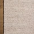 Top view of Thorne Natural Rug with visible wooden floor background on one side