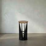 Swivel bar stool with round white oak seat and black iron geometric base with circular footrest