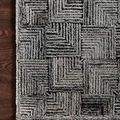 Top corner of Prescott Silver Rug on dark wood floor highlighting edge finishing and pattern scale