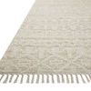 Close-up angled view of the rug showing natural fiber texture and fringe detail