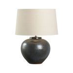 Another view of the Kuro Table Lamp emphasizing darker spots and texture variations on the iron oxide base