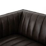 Inner corner of sofa highlighting plush vertical channeling and leather surface