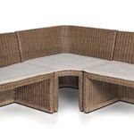 Back corner view of banquette showing woven rattan panels and cushion thickness