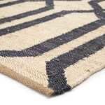 Edge view highlighting thick flatwoven wool and jute fibers of Luxor Natural Trellis rug