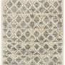 Top-down view showing full geometric pattern in soft taupe and neutral tones with fringed edges