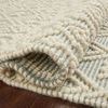 Side angle close-up of folded Noelle Rug showing thick, textured weave and raised wool knots