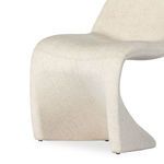 Close-up of front chair base showing continuity of linen fabric and subtle curve