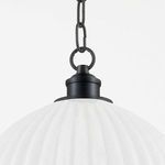 Close-up on top fixture and black metal chain link suspending the fluted pendant light
