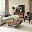 Living room close-up showing wood coffee table with plants, candles, and fuzzy throw on sectional sofa