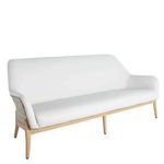 Three-seater outdoor sofa with white vinyl cushions, natural wicker back, and light wood legs