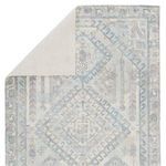 Rug flipped to show cream-colored fabric backing with visible weave pattern