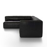 Side view showing depth and clean seam lines of black leather sectional