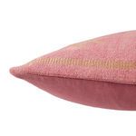 close-up side detail of pillow showcasing textured pink and tan embroidery over cotton weave