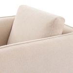 Close-up of cream fabric texture and supportive back cushion