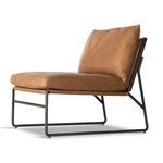 Upper back corner of back cushion showing smooth tan leather on chair with cane and wood back