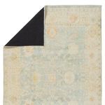Back view showing black non-slip rug pad attached to the zero-pile Lovato Floral Blue/Green Rug