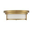 Top-down view focusing on brass ceiling canopy and white glass shade beneath