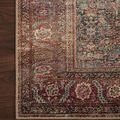 Detailed close-up of Wynter Onyx / Multi rug corner on dark wood floor showing border patterns