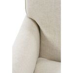Close-up of the armrest’s inward curve and cushion edge