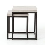 Side angle of nested tables highlighting the linear modern metal frame design