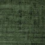 Close-up view of rug’s triangle pattern and delicate hand-carved texture in green