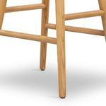 Close-up of solid oak legs and footrest bars with visible wood grain texture