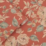 Close-up of rolled wallpaper showing detailed hibiscus and leaves print on crimson background