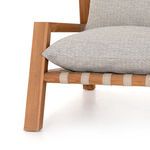 Lower front view of Soren Outdoor Chair showing teak leg, ivory strap, and wide cushion edge