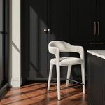 Martens Stool positioned in kitchen setting with dark cabinets and hardwood flooring