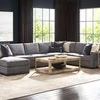 Verge Cocktail Table styled in a living room with sectional sofa, side tables, lamps, and large windows in the background