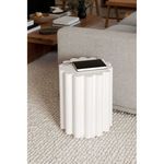 Side view of Taffy Accent Table styled with a notebook on top against a light gray sofa